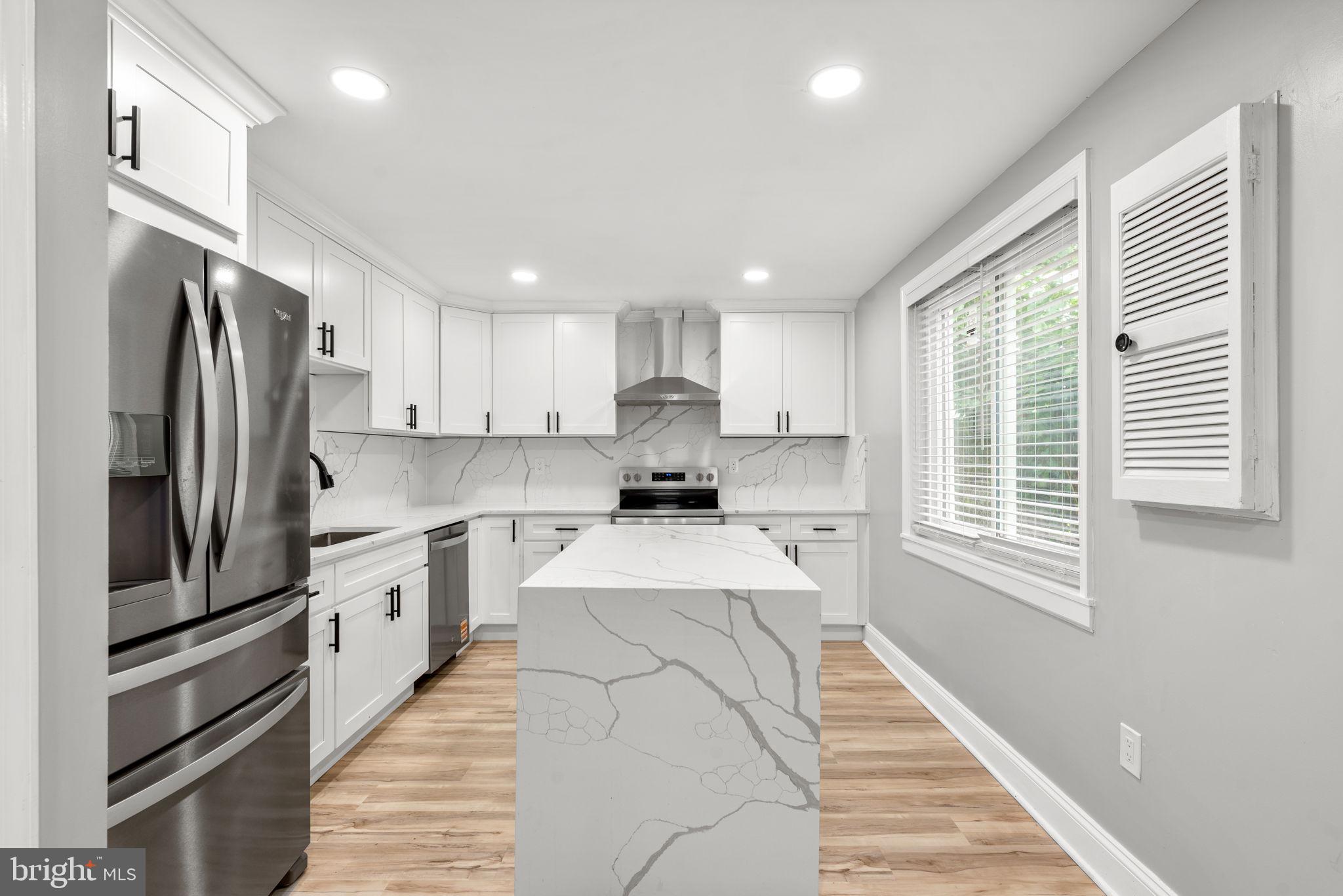 3406 Louth Road Dundalk, MD 21222 - Photo 3 of 30 a kitchen with stainless steel appliances granite countertop a refrigerator sink and cabinets