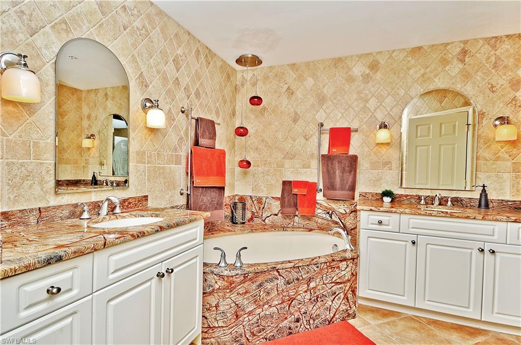 401 Bayfront Place, Unit 3201 Naples, FL 34102 - Photo 11 of 24 a spacious bathroom with a sink a mirror a vanity and a bathtub