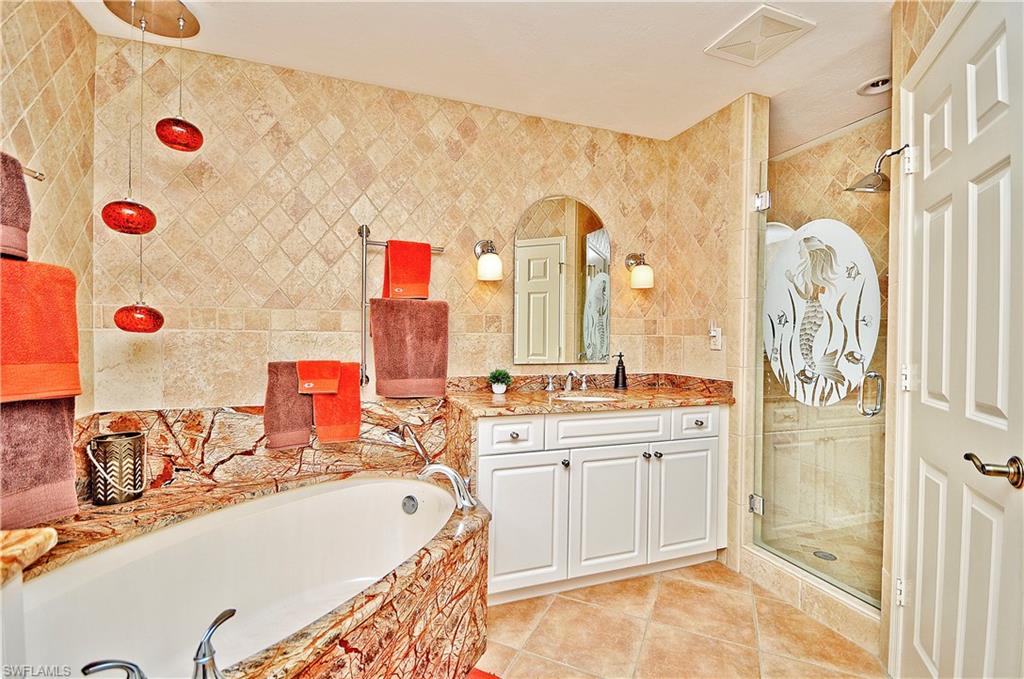 401 Bayfront Place, Unit 3201 Naples, FL 34102 - Photo 12 of 24 a bathroom with a sink vanity tub and shower