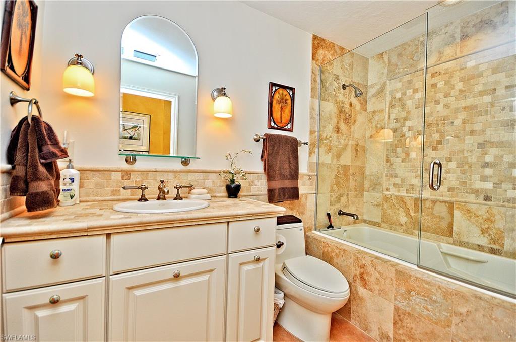 401 Bayfront Place, Unit 3201 Naples, FL 34102 - Photo 15 of 24 a bathroom with a granite countertop toilet sink and mirror