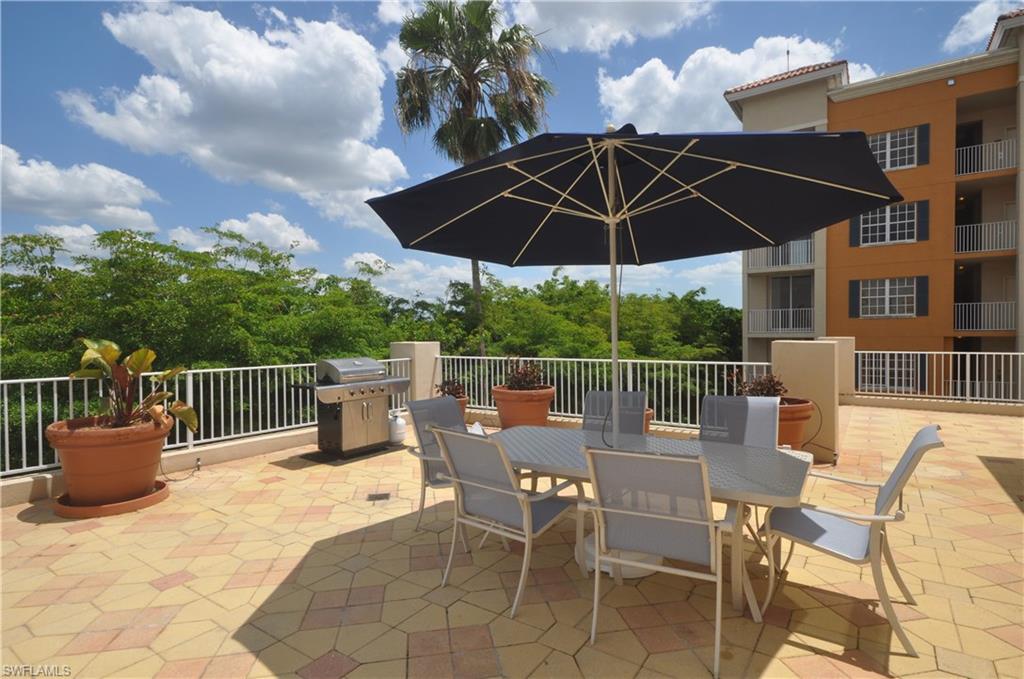 401 Bayfront Place, Unit 3201 Naples, FL 34102 - Photo 21 of 24 a view of a chair and tables in the patio