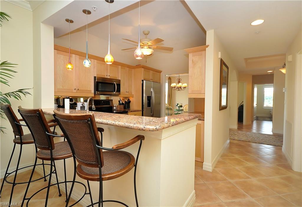 401 Bayfront Place, Unit 3201 Naples, FL 34102 - Photo 4 of 24 a kitchen with a table and chairs in it