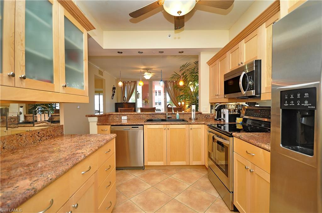 401 Bayfront Place, Unit 3201 Naples, FL 34102 - Photo 6 of 24 a kitchen with stainless steel appliances granite countertop a sink and cabinets