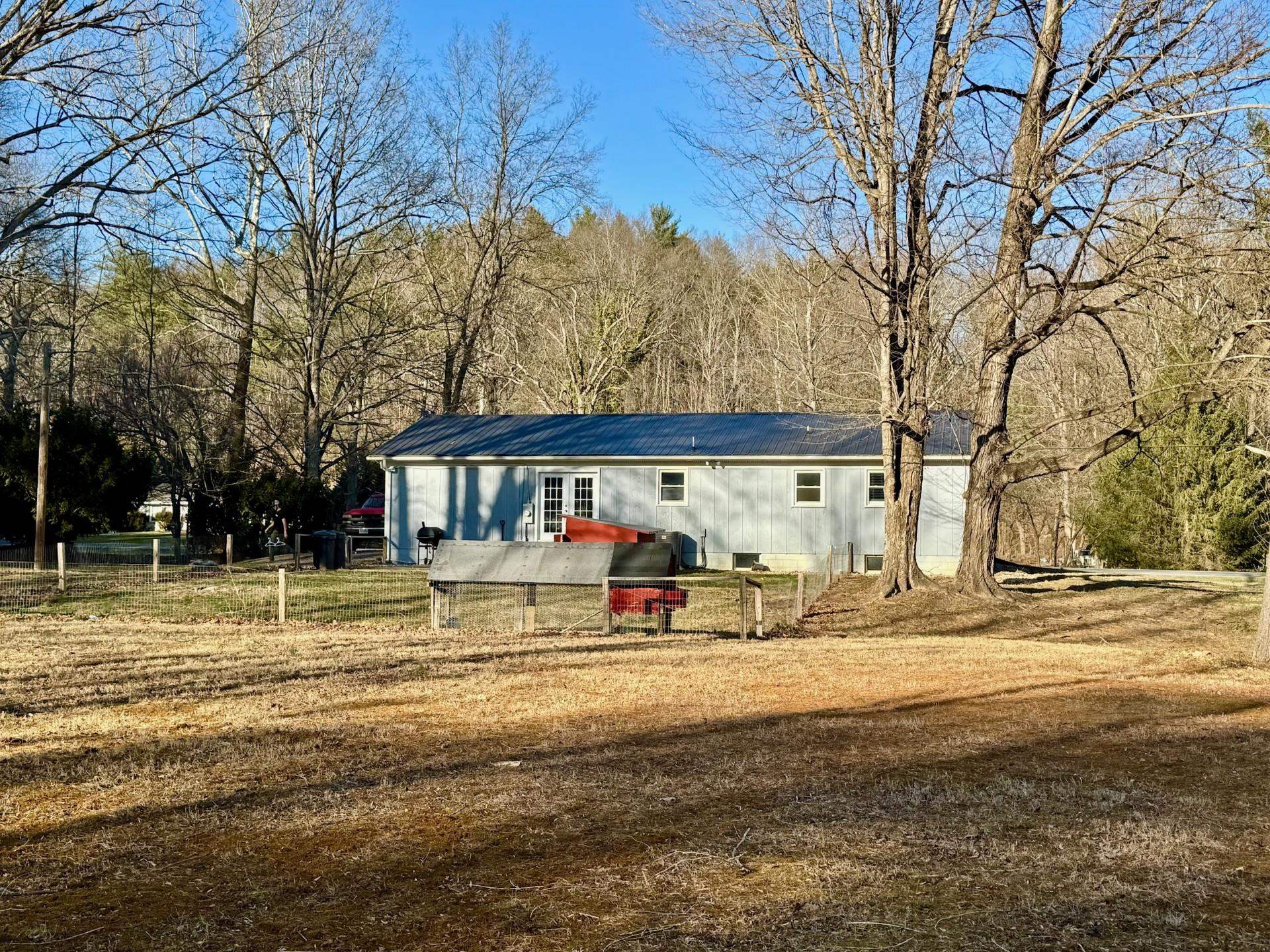 8127 Briery Branch Road Dayton, VA 22821 - Photo 19 of 23 a front view of a house with a yard and large trees