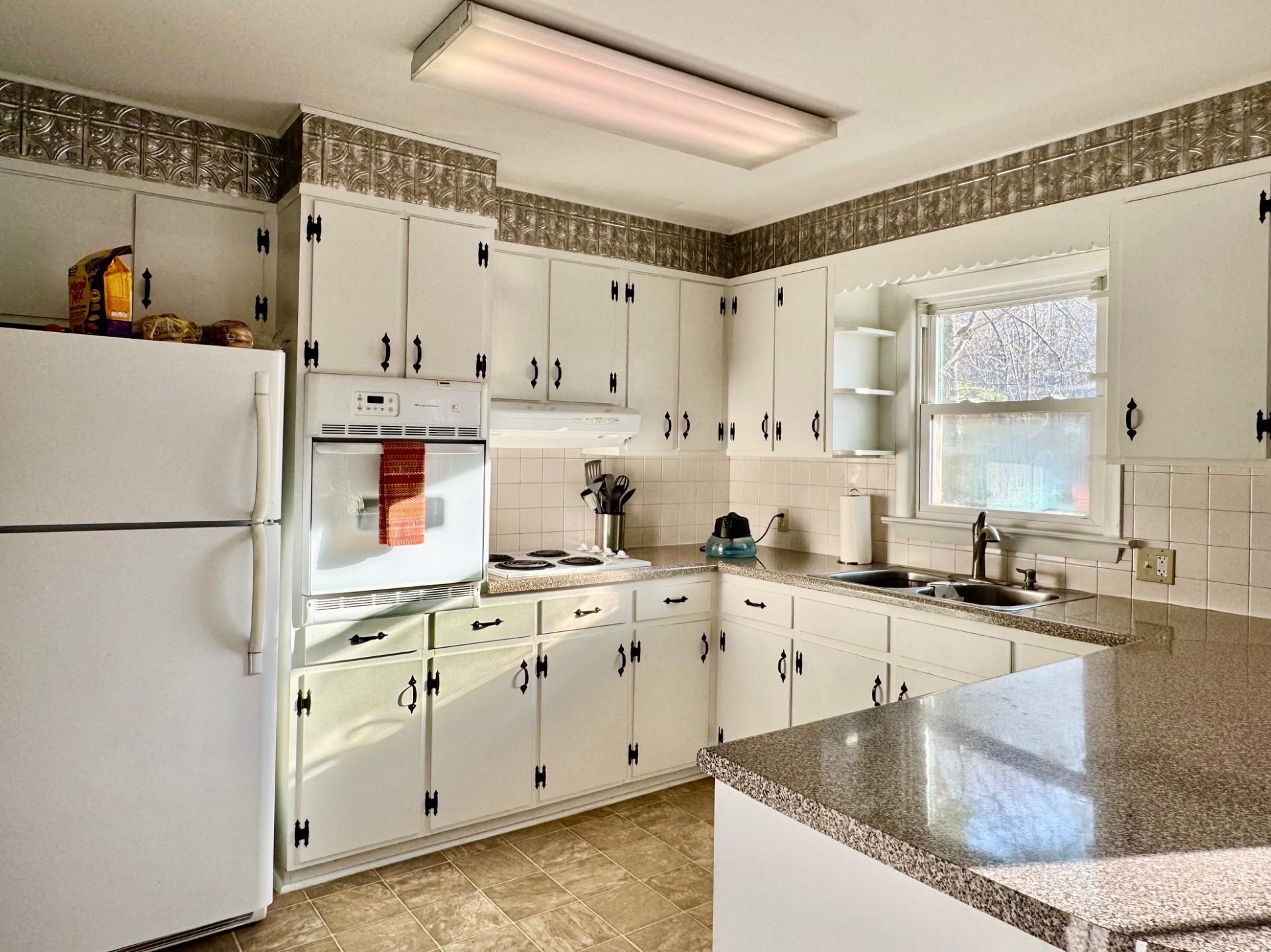 8127 Briery Branch Road Dayton, VA 22821 - Photo 4 of 23 a kitchen with white cabinets and white appliances