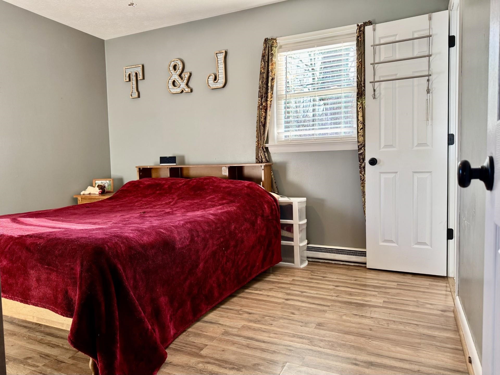 8127 Briery Branch Road Dayton, VA 22821 - Photo 7 of 23 a spacious bedroom with a bed and a window