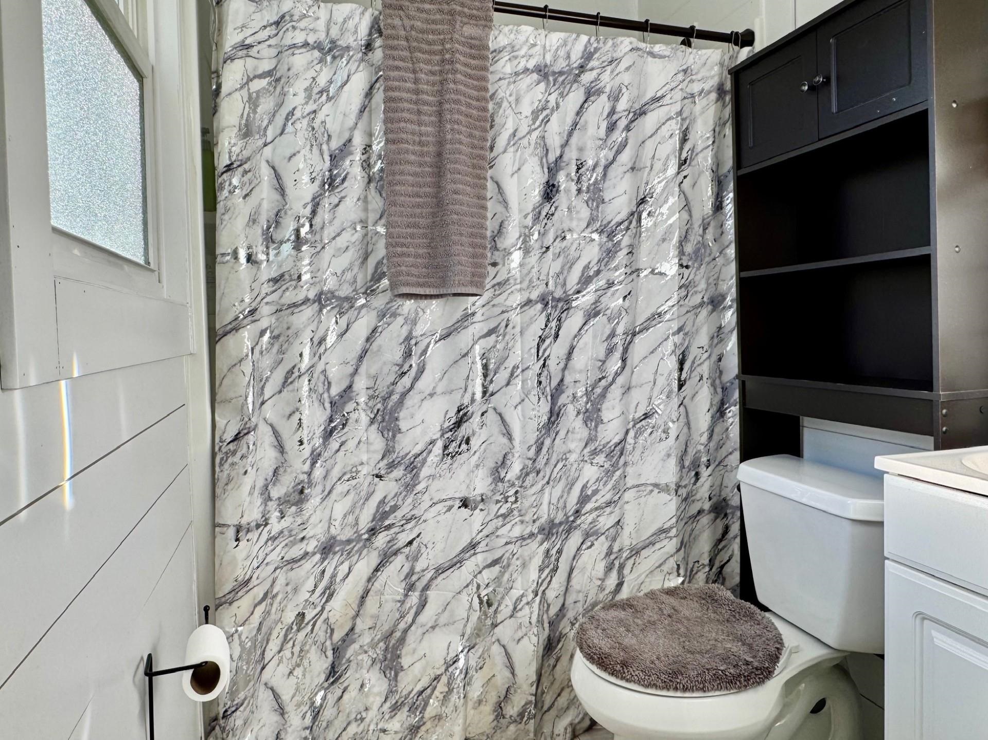8127 Briery Branch Road Dayton, VA 22821 - Photo 10 of 23 a white toilet sitting next to a shower curtain