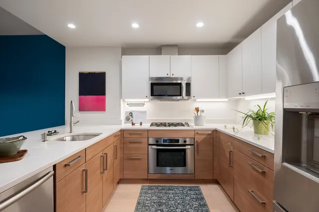 a kitchen with a sink stove and microwave