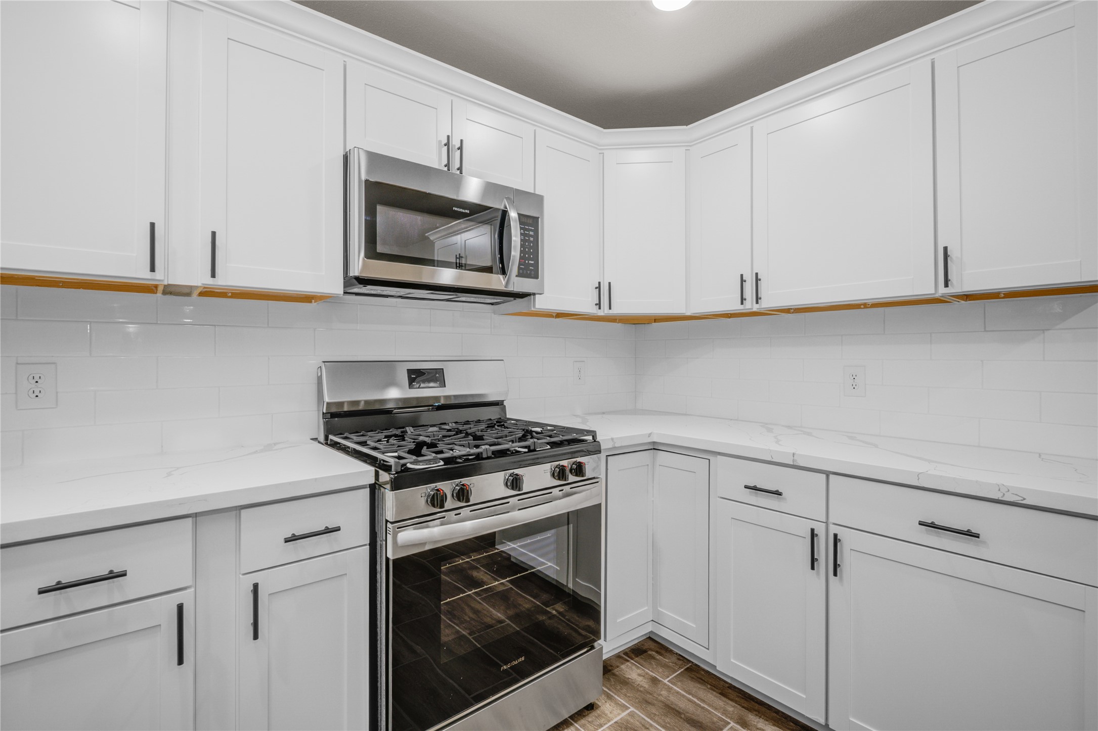 1530 West 10th Street Freeport, TX 77541 - Photo 12 of 32 a kitchen with white cabinets and appliances
