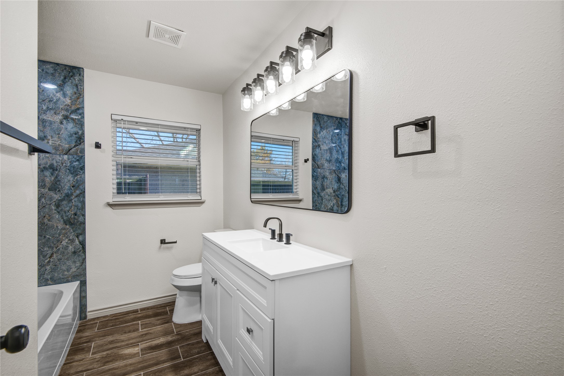 1530 West 10th Street Freeport, TX 77541 - Photo 17 of 32 a bathroom with a sink and a mirror