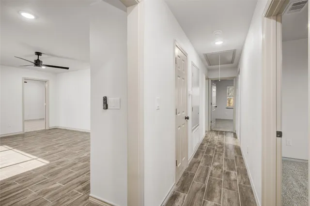 a view of a hallway with a chandelier
