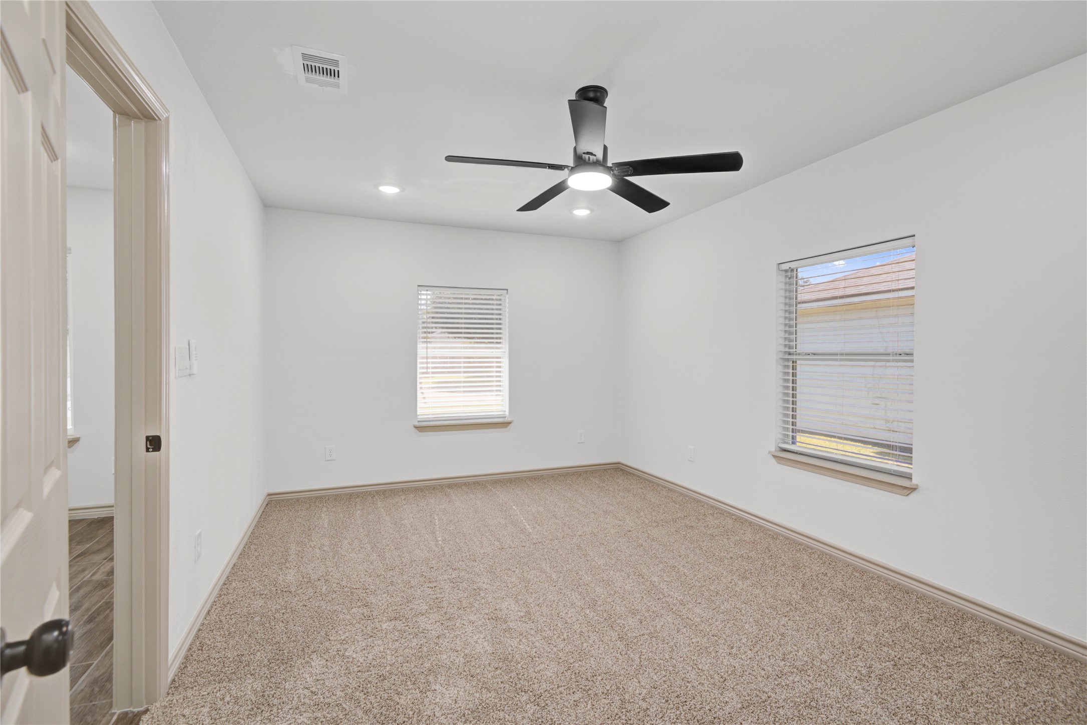 1530 West 10th Street Freeport, TX 77541 - Photo 24 of 32 an empty room with windows and fan