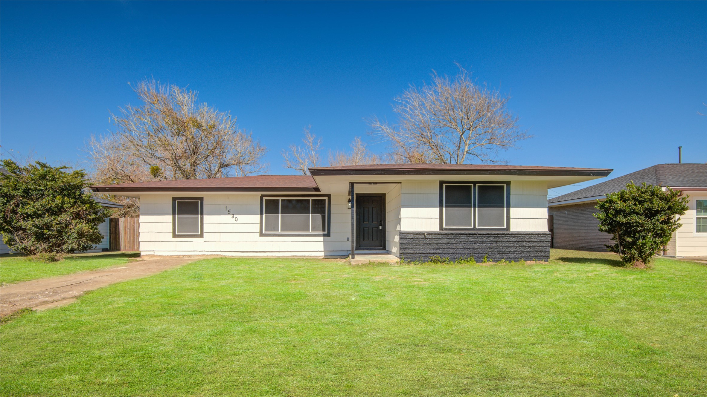 1530 West 10th Street Freeport, TX 77541 - Photo 3 of 32 a front view of house with yard and green space