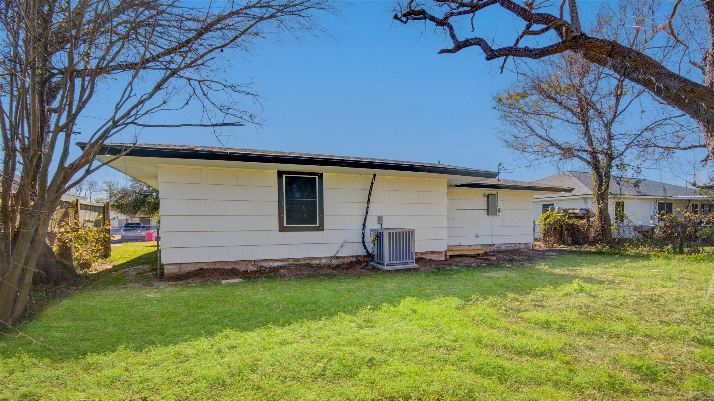 1530 West 10th Street Freeport, TX 77541 - Photo 31 of 32 a view of a backyard with plants and a slide