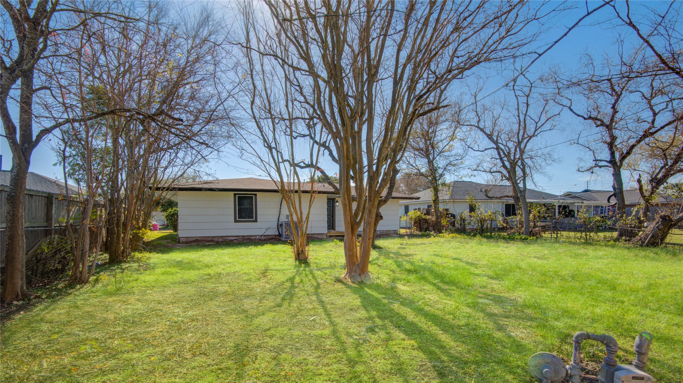 1530 West 10th Street Freeport, TX 77541 - Photo 32 of 32 a view of a yard with a house and a large tree