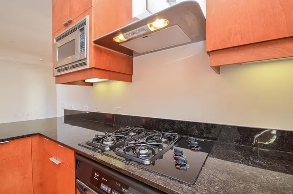 a stove top oven sitting inside of a kitchen