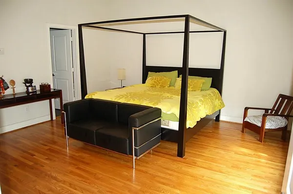 a bedroom with a bed and a desk
