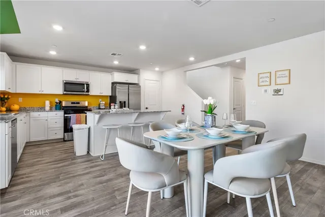 a view of a dining room with furniture and wooden floor