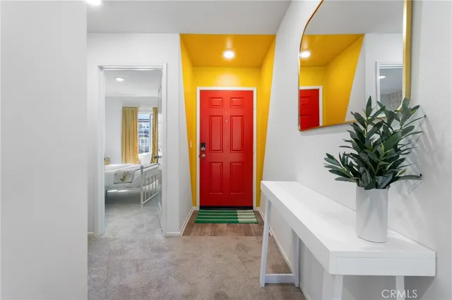 a living room with a couch and a potted plant