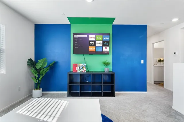 a room with painting on the wall and a potted plant