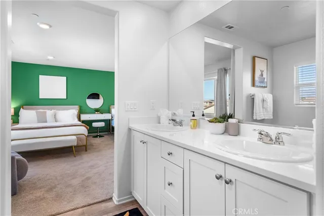 a en suite bathroom with a sink and mirror