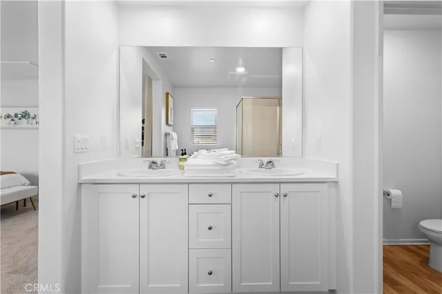 a bathroom with double sink and a mirror