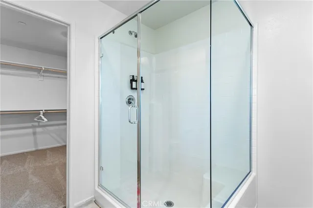 a bathroom with a shower and a glass door