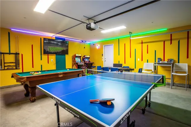 a room with pool table and large windows