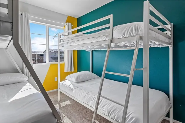 a view of a bedroom with a bed and glass door