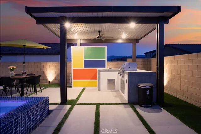 a kitchen with stainless steel appliances kitchen island granite countertop a table and chairs in it