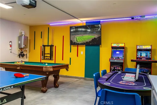 a living room with furniture and a pool table