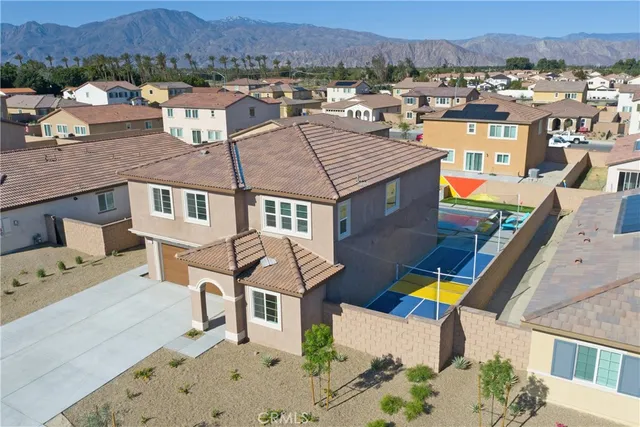 an aerial view of a houses with a swimming pool
