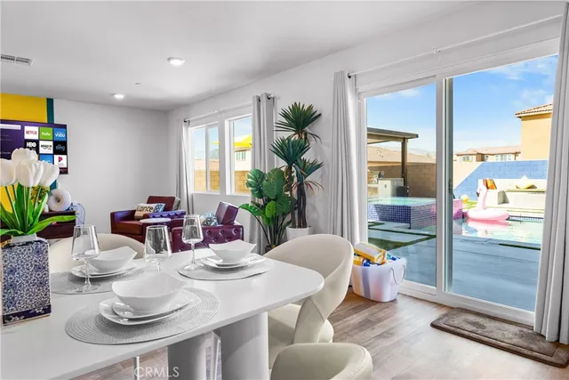 a dining room with furniture and wooden floor