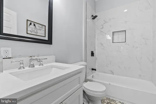 a bathroom with a sink a toilet and a bathtub