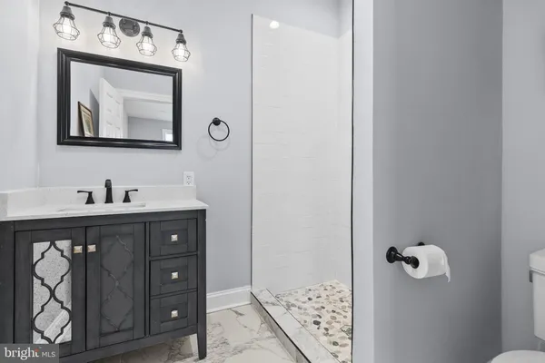 a bathroom with a sink vanity and mirror