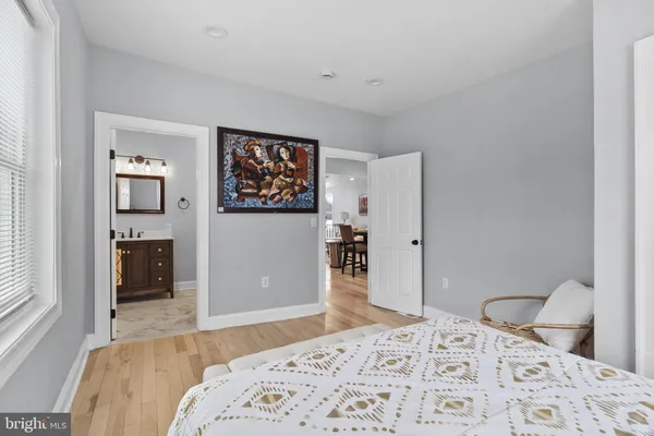 a bedroom with a bed and a dresser