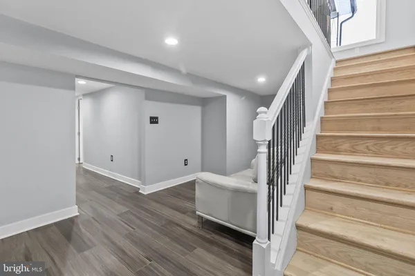 a view of a hallway with wooden floor and entryway