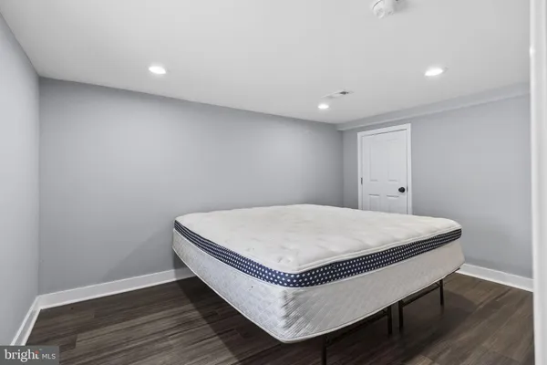 a room with a wooden floor and white walls