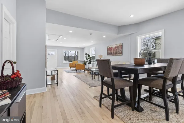 a dining room with furniture and wooden floor