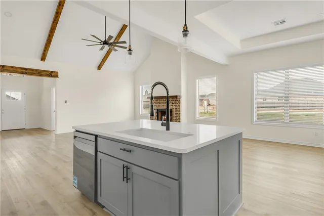 a kitchen with white cabinets appliances and sink