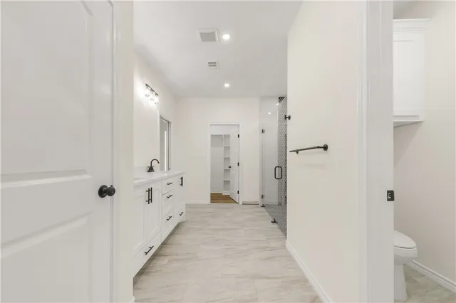 a bathroom with a shower and a sink