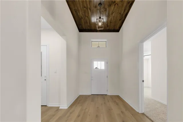 a bathroom with a toilet a sink a mirror a bathtub and vanity