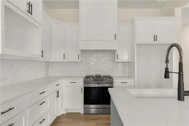 a view with a sink cabinets and wooden floor