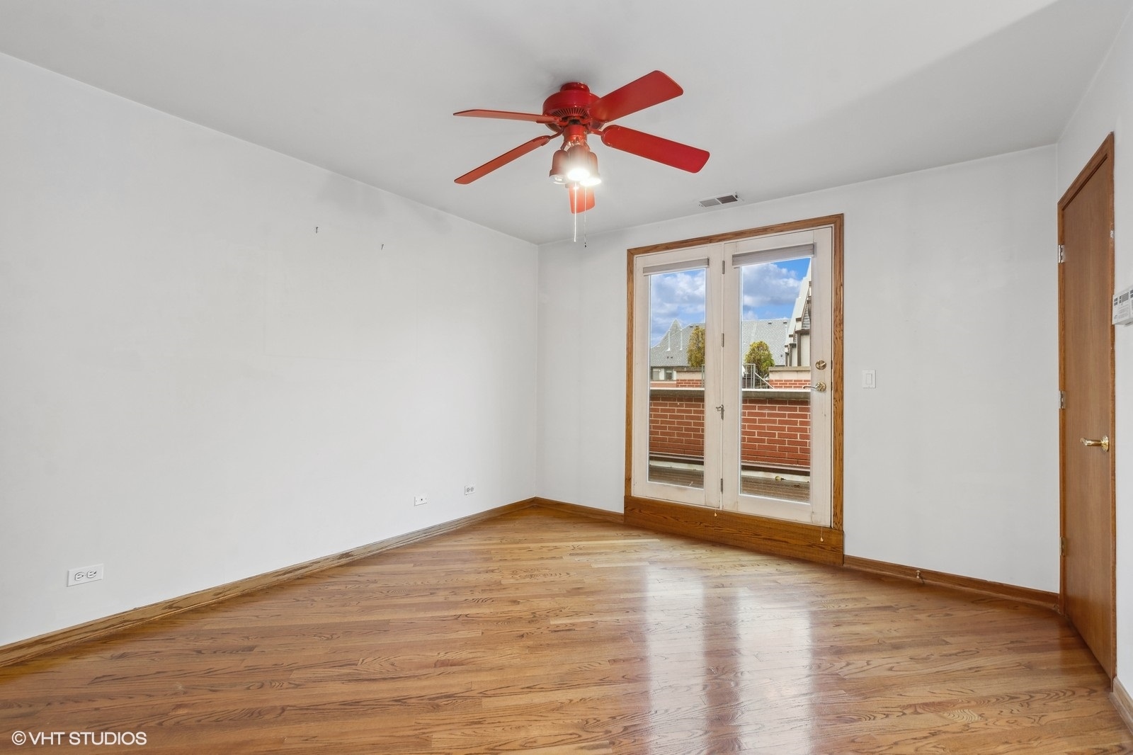 1447 South Indiana Avenue Chicago, IL 60605 - Photo 19 of 23 an empty room with wooden floor ceiling fan and window