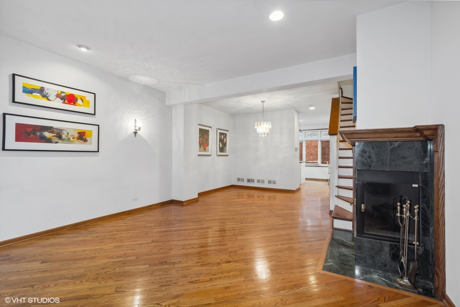 1447 South Indiana Avenue Chicago, IL 60605 - Photo 6 of 23 a view of an empty room with wooden floor and a fireplace