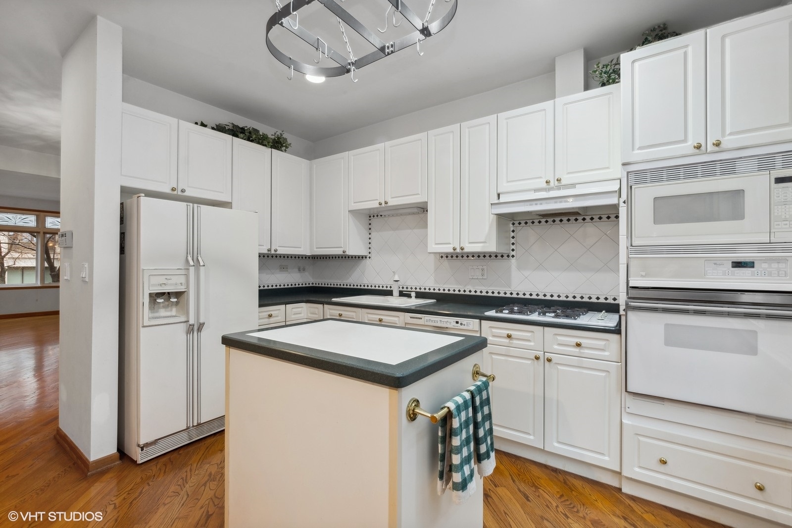 1447 South Indiana Avenue Chicago, IL 60605 - Photo 9 of 23 a kitchen with granite countertop white cabinets and white appliances