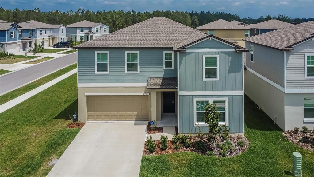 a front view of a house with a yard and garage
