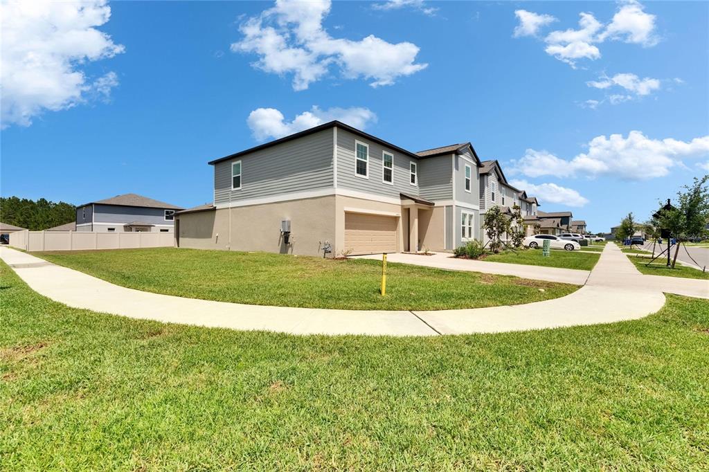 34780 Rainville Loop Zephyrhills, FL 33541 - Photo 2 of 30 a view of a house with a big yard