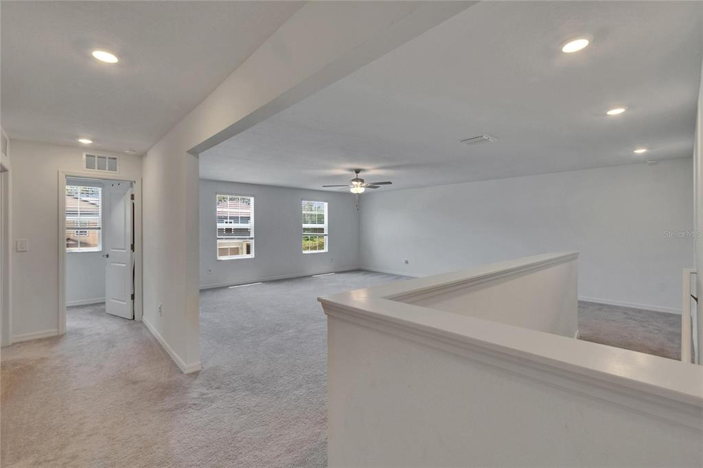 34780 Rainville Loop Zephyrhills, FL 33541 - Photo 24 of 30 an empty room with windows and entrance