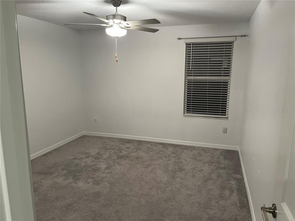 34780 Rainville Loop Zephyrhills, FL 33541 - Photo 26 of 30 an empty room with a window and a fan